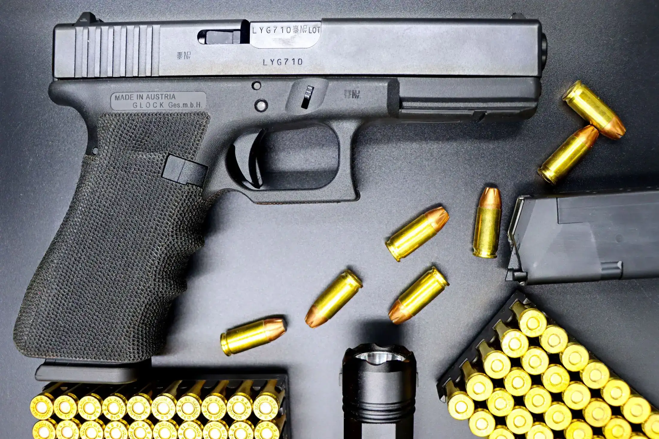 A 9mm pistol and ammunition laid out before a session.