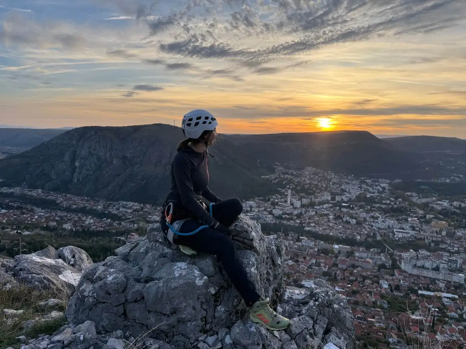 Resting on the summit rocks at sunset, with Mostar below.