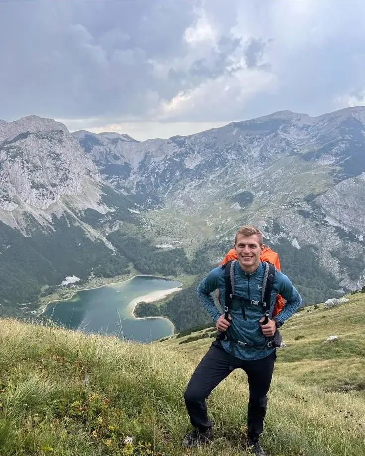 Tarik, BOA hiking guide, on a grassy ridge above Trnovačko Lake below Maglić