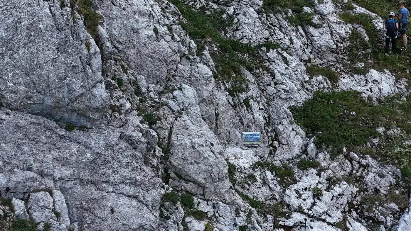 Two climbers at the start sign of the Kotlovi via ferrata on Bjelašnica